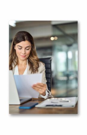 Busy mid aged business woman working in office with laptop reading document. Mature professional female manager lawyer attorney holding paper finance report sitting at desk in office. Copy space