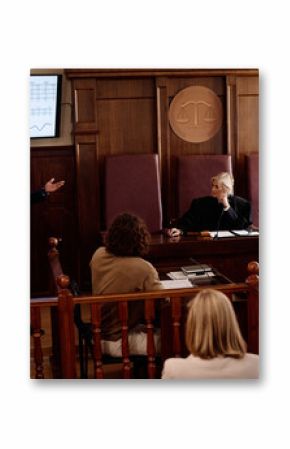 Young confident African American attorney making presentation of summary of results while standing by screen with statistic data