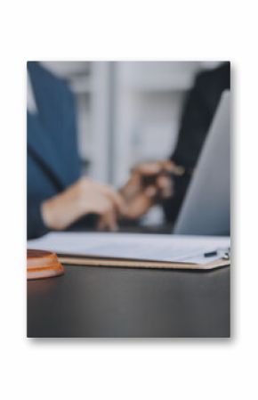 Business and lawyers discussing contract papers with brass scale on desk in office. Law, legal services, advice, justice and law concept picture with film grain effect