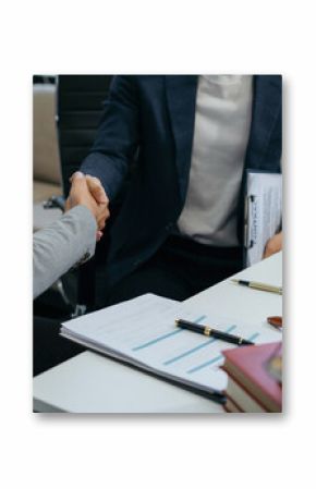 Middle age partner lawyers attorneys shaking hands after discussing a contract agreement done.