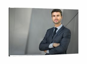 Businessman posing confident and positive in professional workplace office with space 
