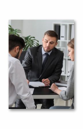 Unhappy young couple visiting divorce lawyer in office