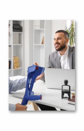 Male lawyer consulting man with crutches in office