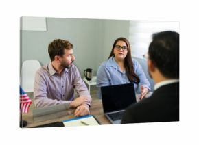 Serious couple receiving immigration legal advice from attorney