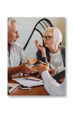 Dishonest contractor. Angry elderly couple sit at broker manager office demand compensation for breach of contract bad service. Annoyed mature spouses scam victims complain lawyer on commercial fraud