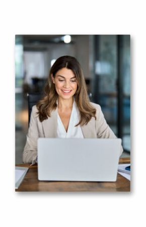 Happy mature business woman entrepreneur in office using laptop at work, smiling professional middle aged 40 years old female company executive wearing suit working on computer at workplace.