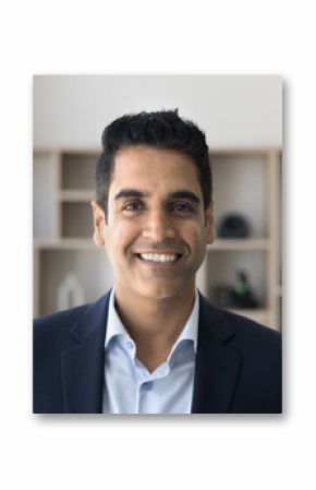 Goal-oriented successful mature Indian businessman dressed in jacket posing at workplace, looking at camera, feel satisfied and happy with career or own business growth, head shot close up portrait