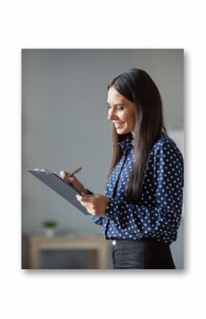 Profile side photo of happy charming woman hold clip board write plan list good mood in office indoors workplace