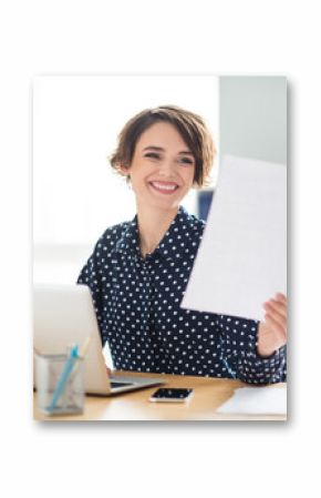 Portrait of attractive cheerful girl finance specialist researching assignment reading note plan strategy at work place station indoors