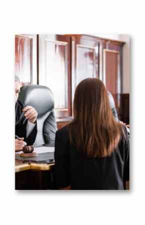 thoughtful judge holding eyeglasses listen to prosecutor standing near attorney in court