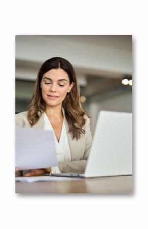 Busy 40 years old business woman working in office checking documents. Mid aged businesswoman accounting manager executive or lawyer using laptop reading paper file financial report, tax invoice.