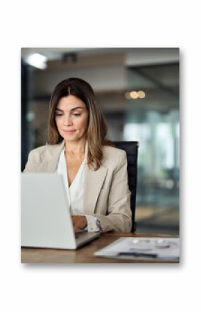 Busy mature middle aged professional business woman manager executive looking at laptop computer technology in office working on digital financial banking market sitting at desk. Copy space.