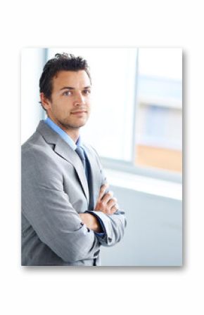 Portrait, serious and business man with arms crossed in workplace, corporate office or company pride. Face, professional employee and confident lawyer in suit, attorney or consultant working in Spain