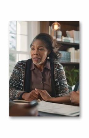 Three African American Women Talking and Looking at Documents.