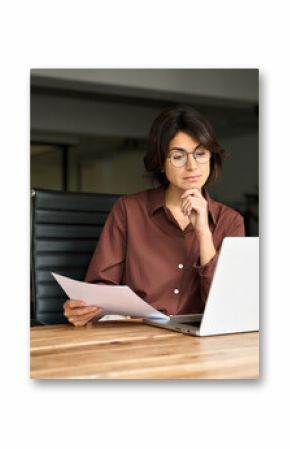 Busy serious young business woman manager working in office checking law document account invoice thinking in office. Businesswoman ceo executive or legal expert using laptop computer at work.