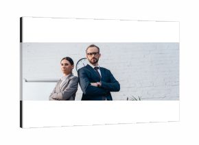 horizontal image of lawyers in suits standing with crossed arms