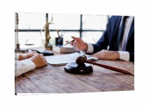 Two lawyers Consultation and conference discussing legal matters at a desk with a gavel, scales of justice law symbolizing law and justice, justice and lawyer Business partnership meeting concept.  