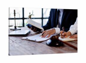 Two lawyers Consultation and conference discussing legal matters at a desk with a gavel, scales of justice law symbolizing law and justice, justice and lawyer Business partnership meeting concept.  