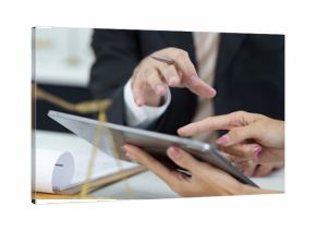 Legal Consultation and Digital Engagement. A lawyer guiding a client through documentation on a tablet during a meeting.