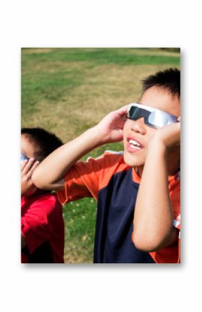 Asian Kids Looking at Solar Eclipse Using a Solar Lens Glasses