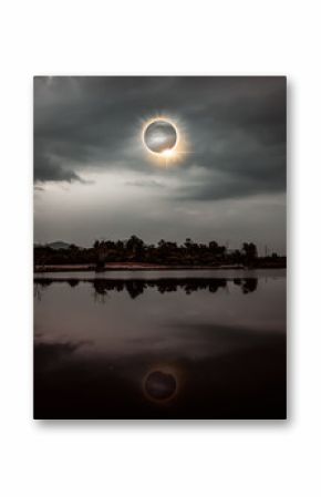 Scientific natural phenomenon. Total solar eclipse with diamond ring effect glowing on sky.