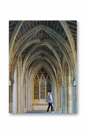 A student walks past the gothic arches at Duke Chapel on the campus of Duke University in Durham North Carolina