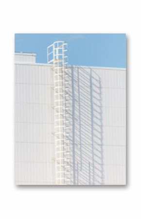 A white ladder on a building with a blue sky in the background