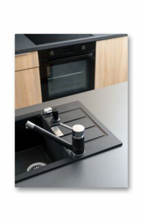 Elegant modern kitchen sink with black countertop and stylish faucet design