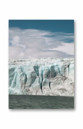 Vertical view of glacier cracking into the sea in summer