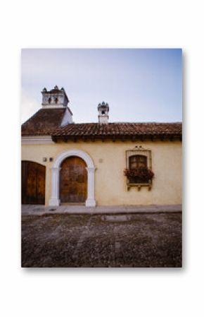 Colonial building with arched door and flowered window in Antigua