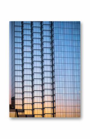 Close up view of Glass building exterior view with sunset sky reflection.
