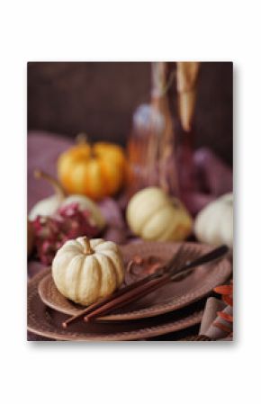 An elegant autumn table arrangement featuring white pumpkins, muted pink dishware, and natural elements. Ideal for Thanksgiving celebrations, fall gatherings, and seasonal home decor ideas
