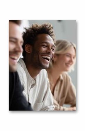 Group of friends enjoying a laughter-filled moment during a casual meeting in a bright indoor setting