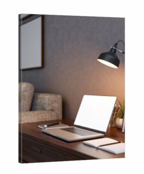 White screen laptop with books and pencil under lamp light in a dim lit living room or bedroom.