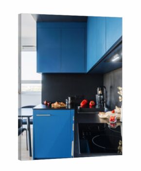 Modern kitchen with blue cabinets and black accents in stylish apartment