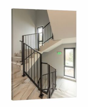 Modern stair case between floors. Stairs with metallic rail in modern building. Interior of a contemporary apartment or office building. Architecture and real estate background.