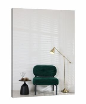 Stylish lamp, comfortable armchair and side table with decor near white wall indoors. Interior design