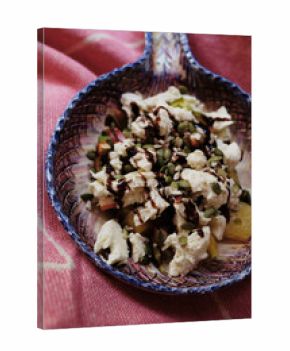 Fresh salad with cheese, seeds, and balsamic drizzle on fabric