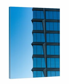 Contemporary high-rise structure with reflective glass windows and geometric lines, set against a clear blue sky. Suitable for illustrating urban architecture, business, or real estate concepts.