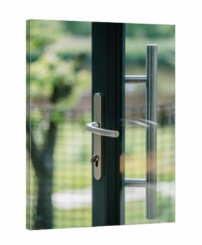 Modern front door with transparent glass and sleek handle in residential setting