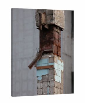 A Close-Up Of A Ruined Industrial Column With Broken Tiles, Rusted Rebar, And Crumbling Concrete.