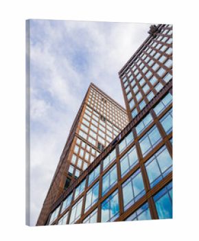Modern office building facade in Gothenburg showcasing a blend of glass and wood under a cloudy sky