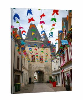 the shopping street in la ferte bernard with the the Saint Julien gate