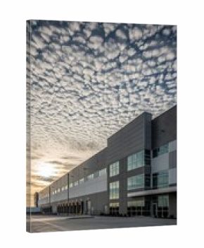 Modern Industrial Building Under a Dramatic Sky at Sunset.