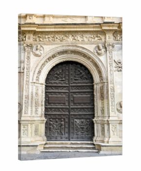 The renaissance wooden door with Latin inscriptions on the Plateresque facade of Seville Town Hall.