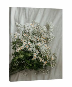 White Bouquet on White Sheet in Sunlight
