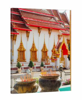 Incense burners in front of temple facade at Wat Chalong, Phuket