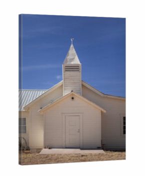Rural white church against blue sky vertical
