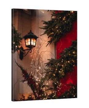 Christmas New Year's magic outdoor decorations, street decorated with golden lights, burning lantern, garlands on Christmas trees, the atmosphere of winter holiday celebration