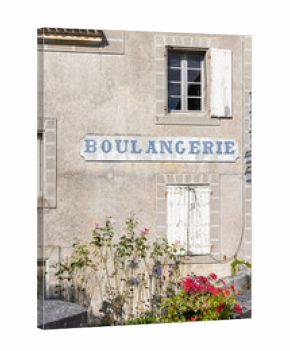 Traditional boulangerie shopfront with blooming flowers in Combiers France
